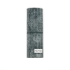 A studio shot focusing on the distinct, weathered-stone appearance of the Nomad fragrance bottle.